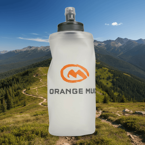 Orange Mud UltraFlask 500 ml / 17 oz soft flask with locking bite valve on a mountain trail