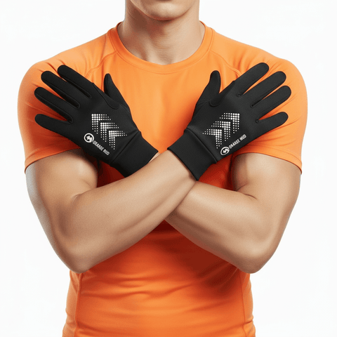 Person wearing black gloves with a brand logo, standing against an orange shirt background