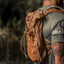 Runner wearing the brown Adventure Pack 12L, side view