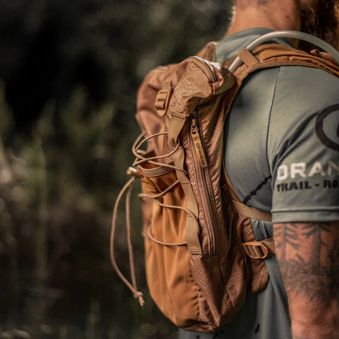 Runner wearing the brown Adventure Pack 12L, side view