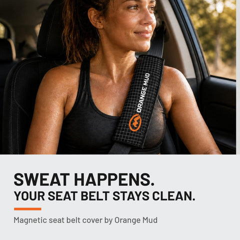 Woman driving with the Orange Mud Seat Belt Wrap on her seat belt