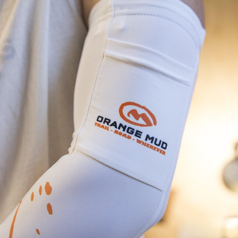Close-up of the white Arm Cooler sleeve with Orange Mud logo